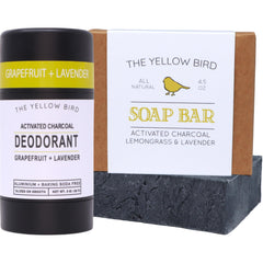 The Yellow Bird charcoal deodorant stick close-up showing odor-control formula.