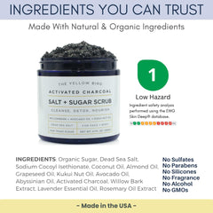 The Yellow Bird charcoal scrub applied to the face for gentle exfoliation.