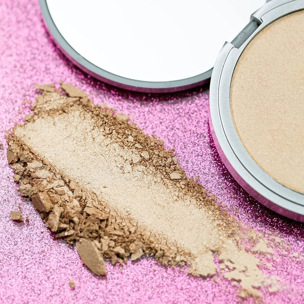 theBalm Mary-Lou Manizer swatch shows champagne shimmer on skin