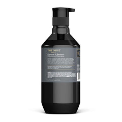 Theorie Detoxifying Shampoo packaging front highlights purifying ingredients for refreshed strands.