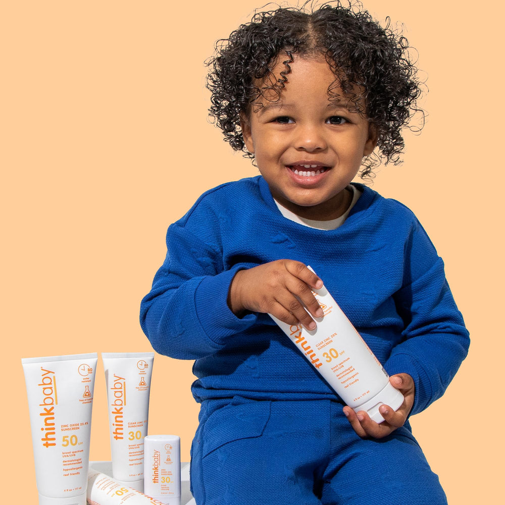 Thinkbaby sunscreen on a child during water play with up to 80 minutes water resistance.