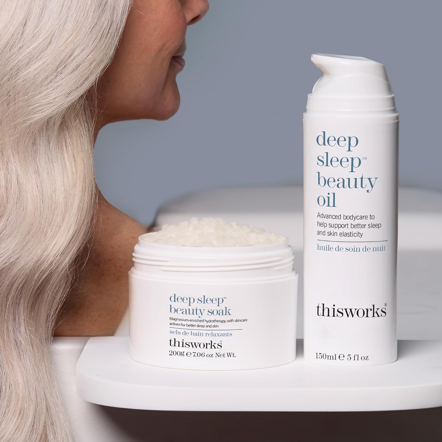 THISWORKS Deep Sleep Beauty Oil bottle beside a softly lit nightstand for a calming routine.