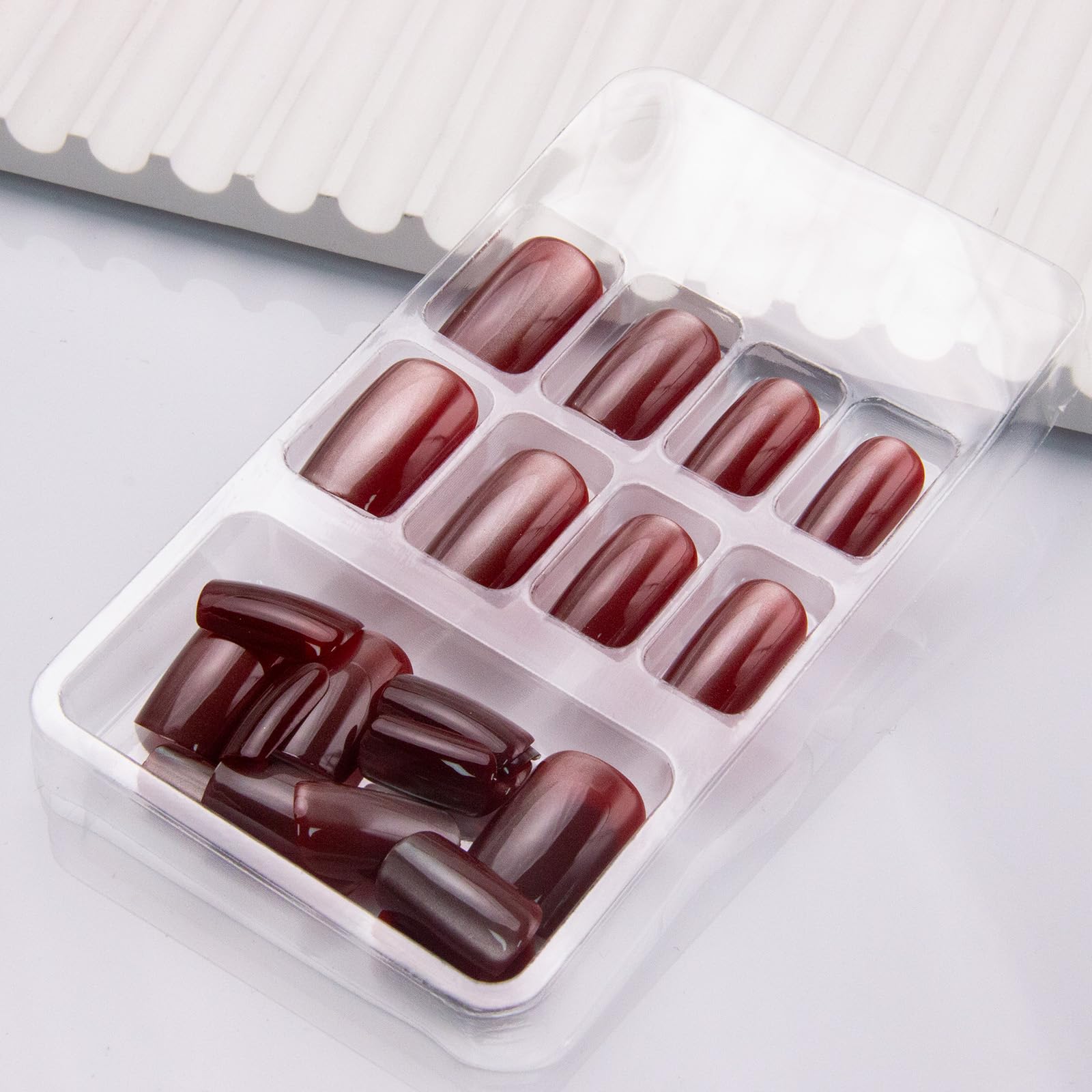 Thuoxde red glossy nails close-up with vibrant shine