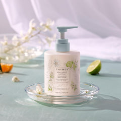 Thymes Bergamot Nectar Lotion bottle closeup highlights creamy texture for nourished skin.