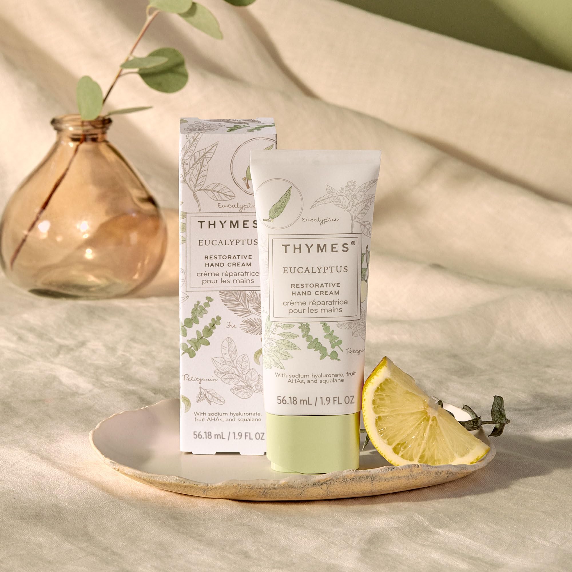 Thymes hand cream fragrance swirls highlighting eucalyptus and lemon notes for a spa-like aroma.