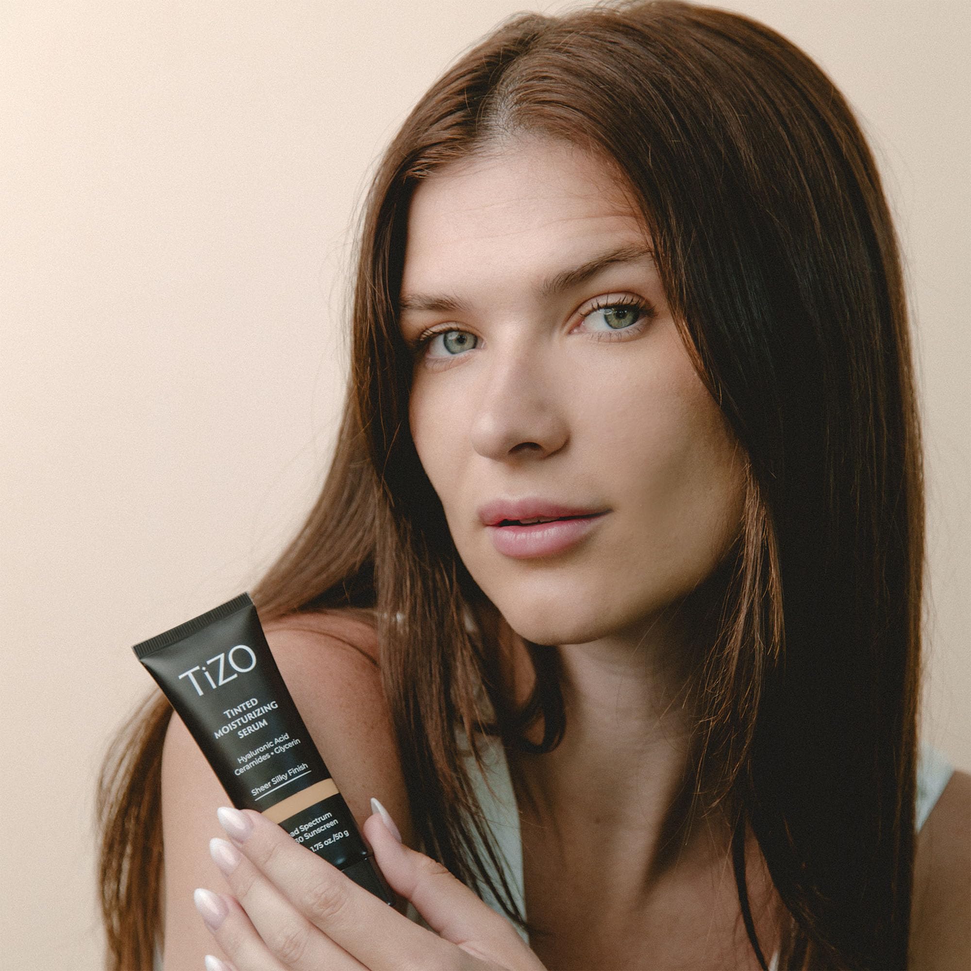 TIZO tinted formula swirl demonstrates sheer blend into skin