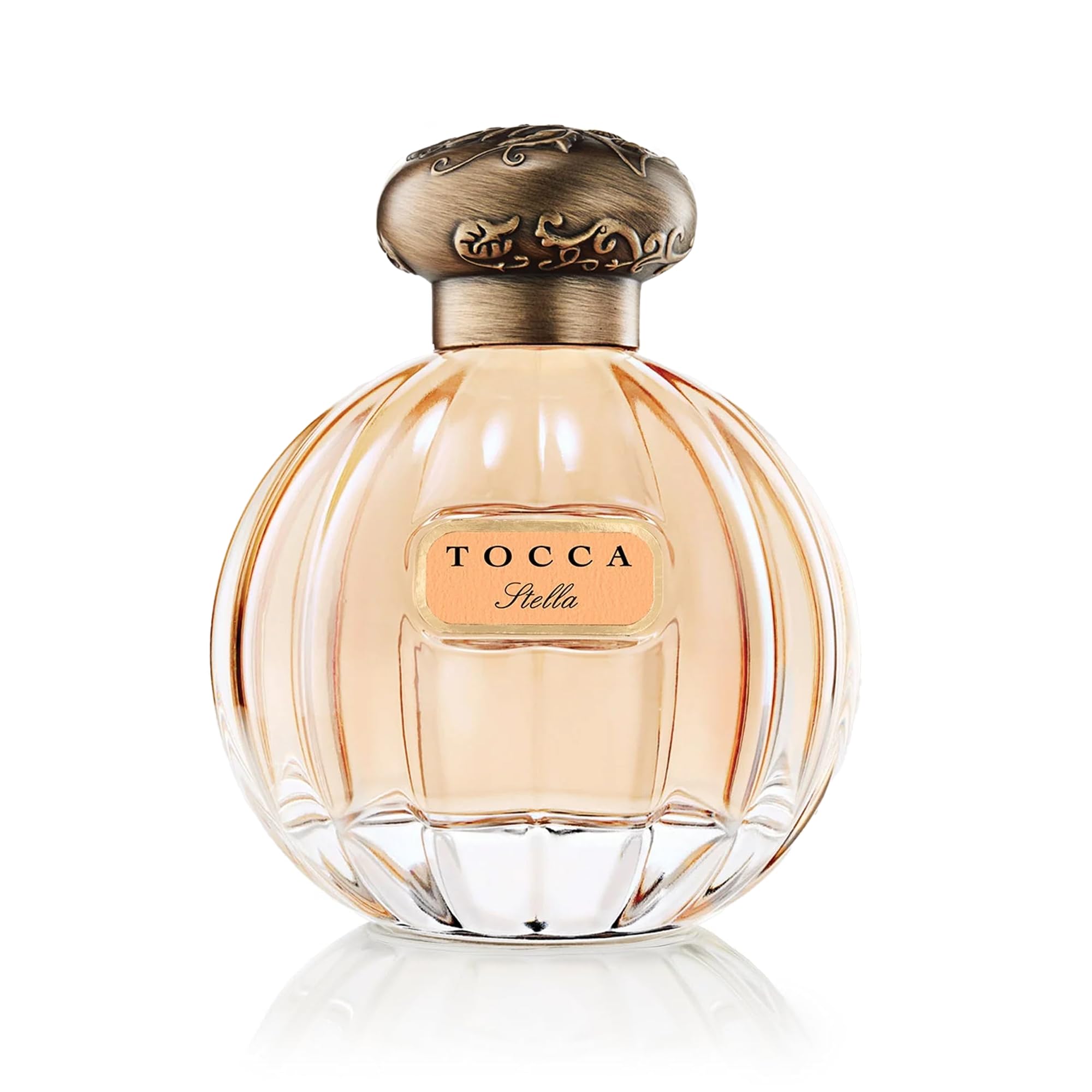 TOCCA Stella bottle close-up showing label and glass texture.