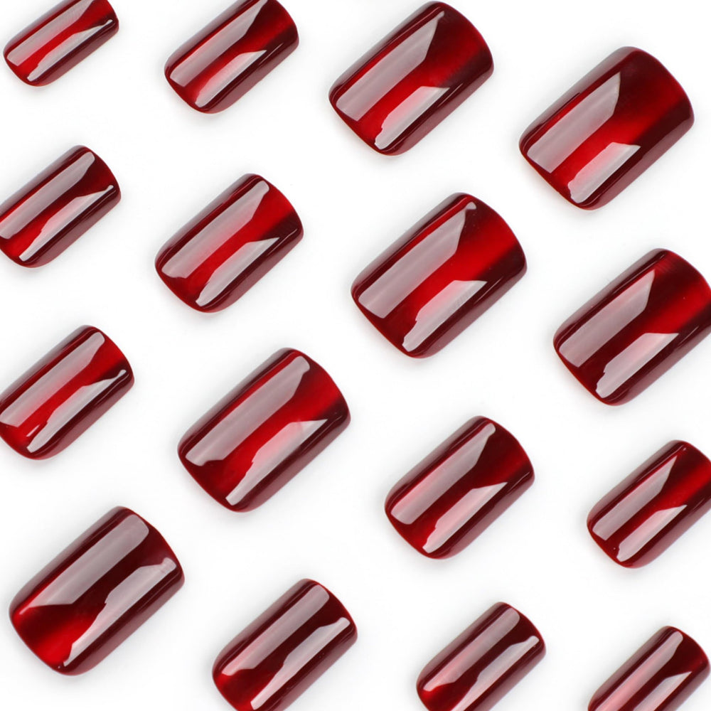 TOGZOM red cat-eye effect nails highlighting dramatic face of nails.