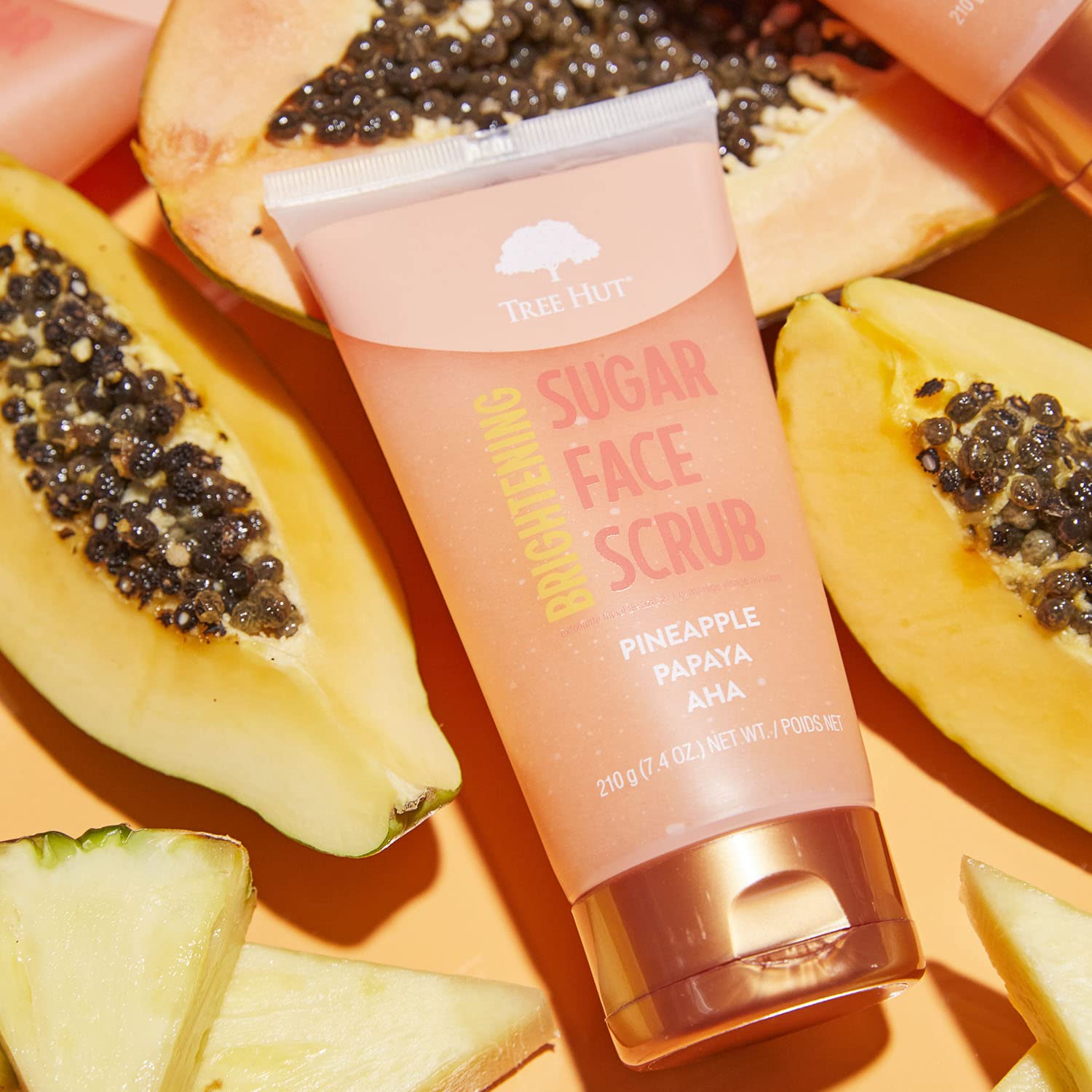 Tree Hut Pineapple Papaya Scrub tub displayed on bathroom shelf.