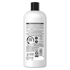 TRESemmé Purple Blonde Conditioner being poured for even distribution.