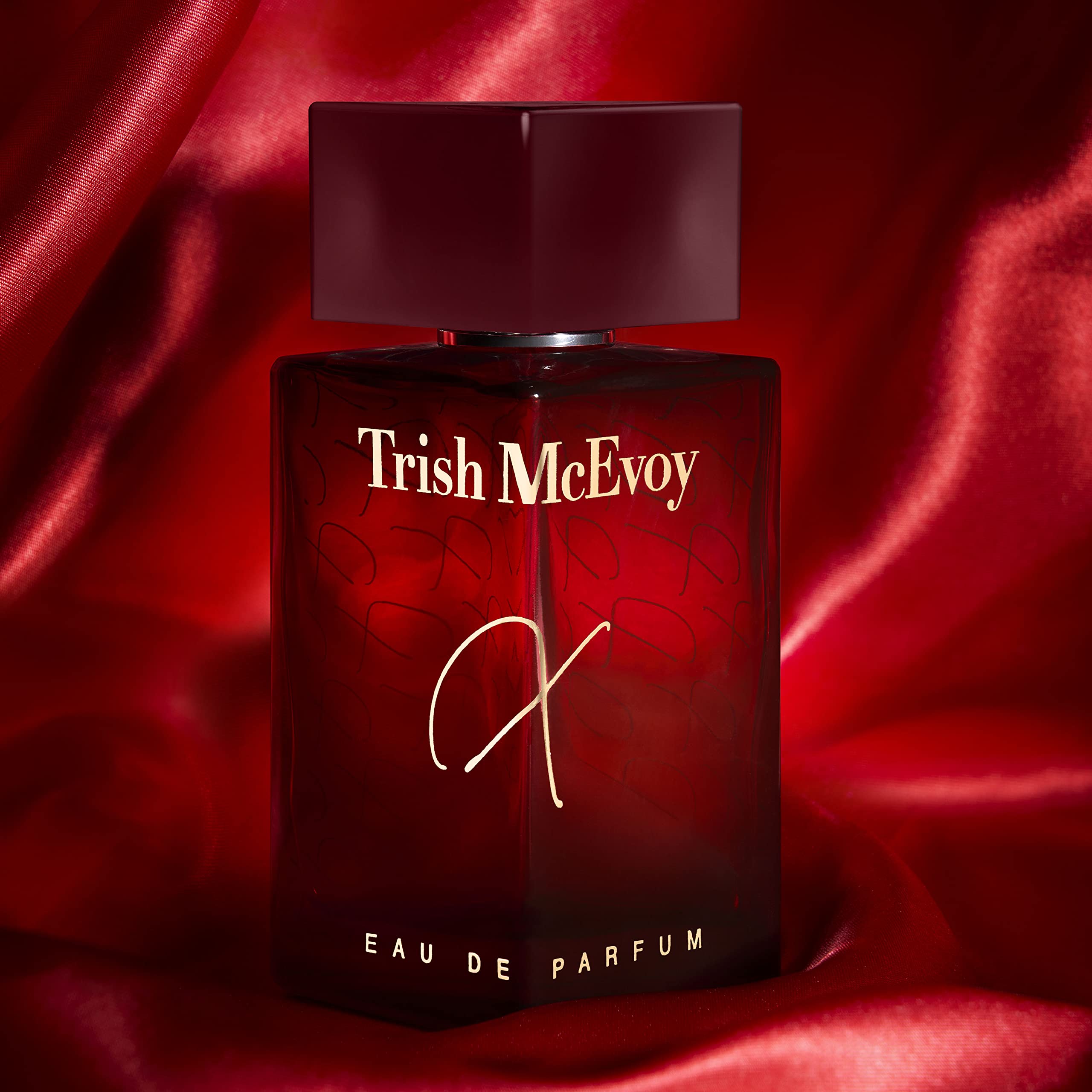 Trish McEvoy Fragrance X bottle closeup highlights warm amber hues and saffron hints.