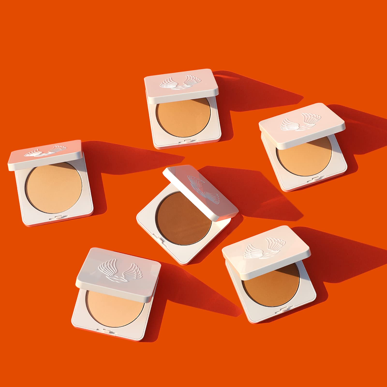 Warm beige shade swatch of True + Luscious Sheer Halo Powder on skin