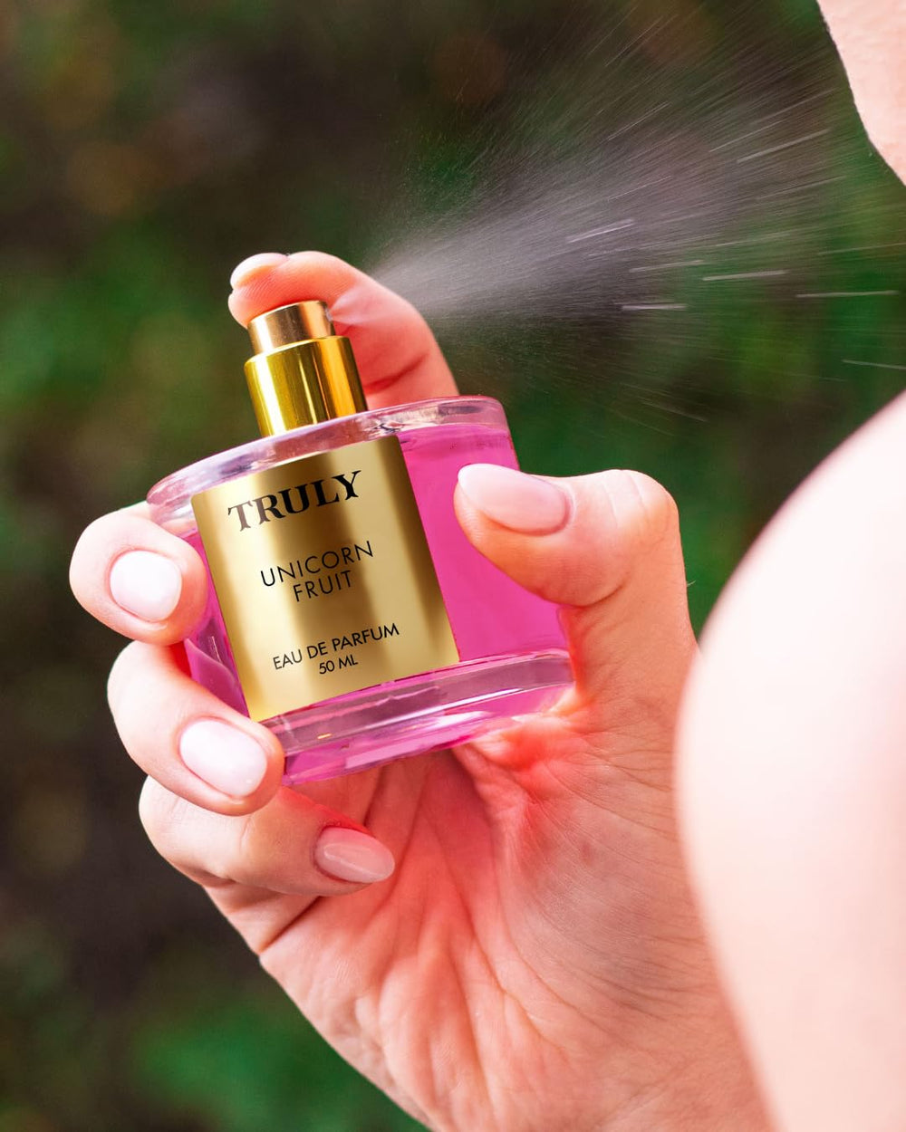 Close-up of spray mist from Truly Unicorn Fruit EDP for light daily wear.