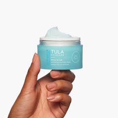 TULA Detox mask applied on the cheek showing cleansing and exfoliation benefits.