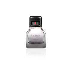 Close-up of TUMI AWAKEN bottle showing woody base notes.