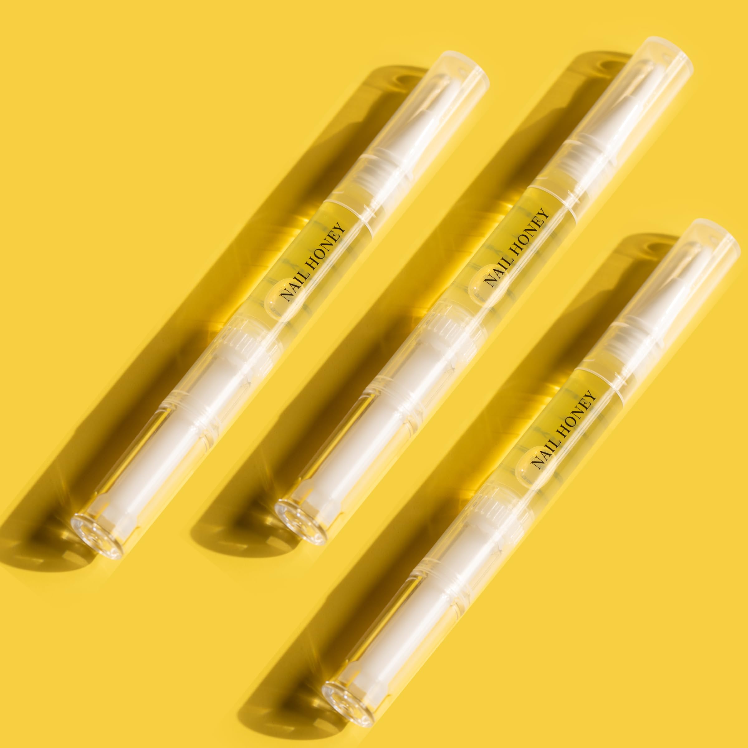 Twinkled T Nail Honey pen application image demonstrating precise cuticle nourishment.