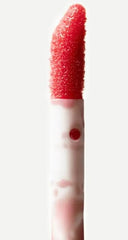 Closeup of Typology lip oil being applied for instant hydration.