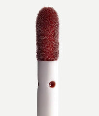 Typology lip oil application on lips with a non-sticky shine.
