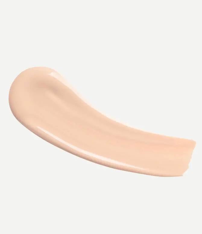 TYPOLOGY Tinted Serum brush application showing even coverage for a radiant complexion