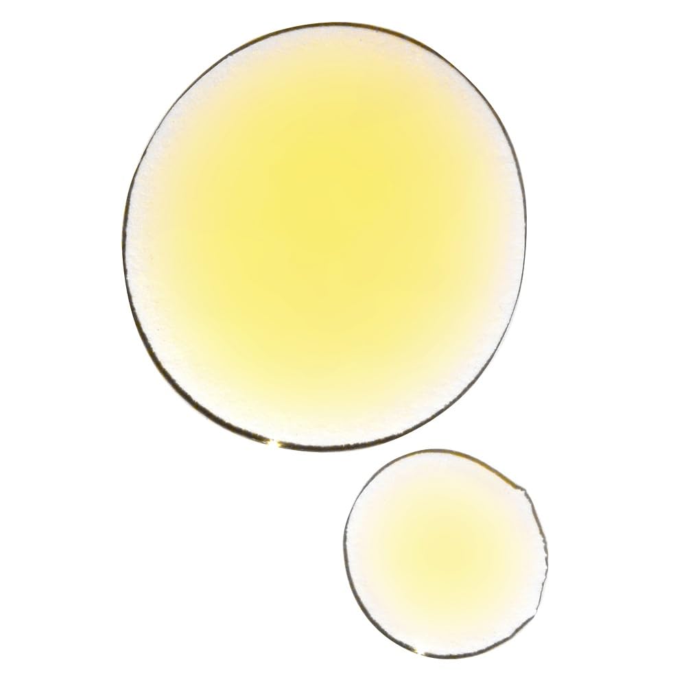UMA Organic Ultimate Brightening Face Oil in hand ready for fast absorption and glow.