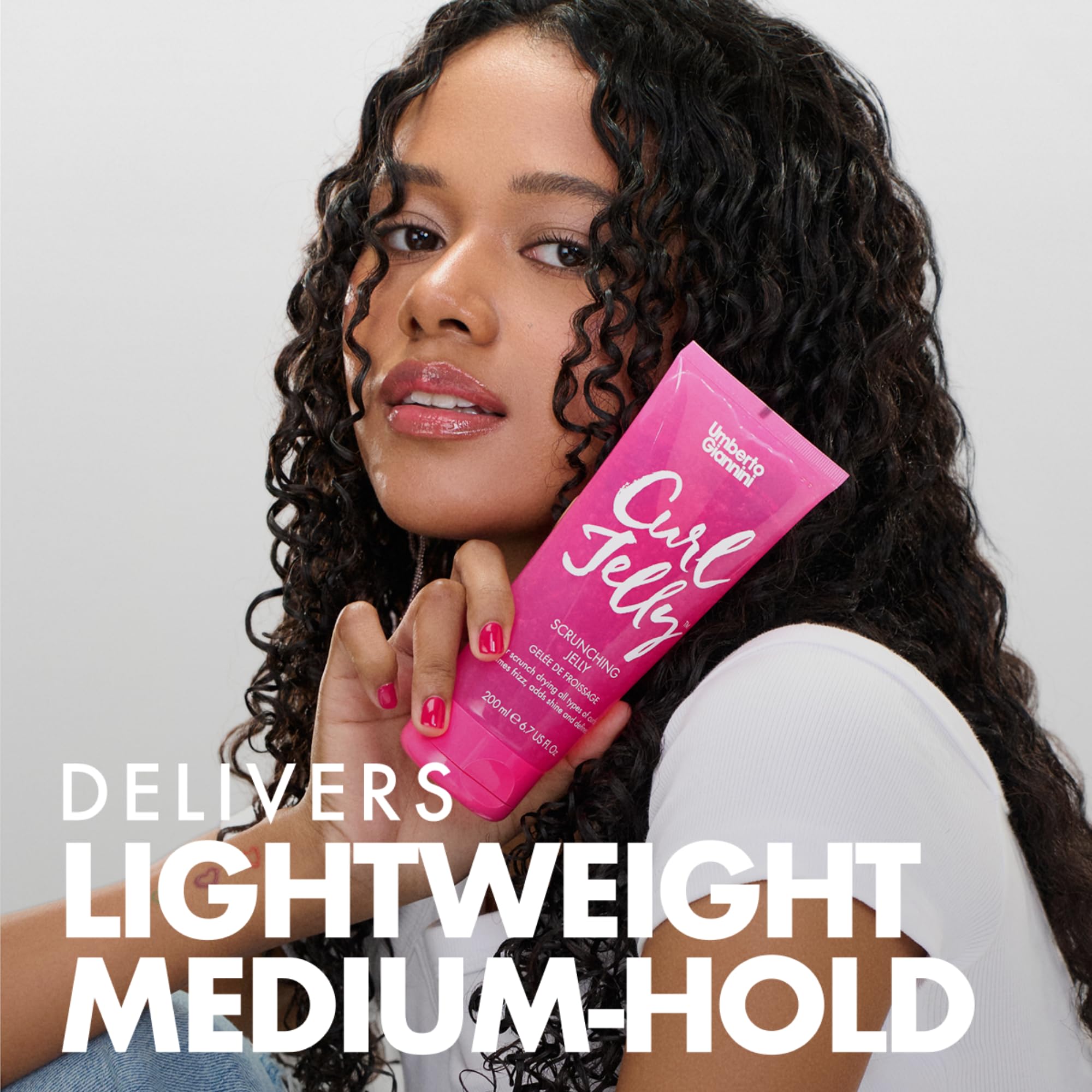 Damp hair with Curl Jelly being scrunched for smooth texture and shine.