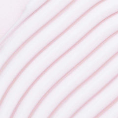 Hands applying Umberto Giannini More Than Moisture Cream to damp hair for smooth, defined twists.