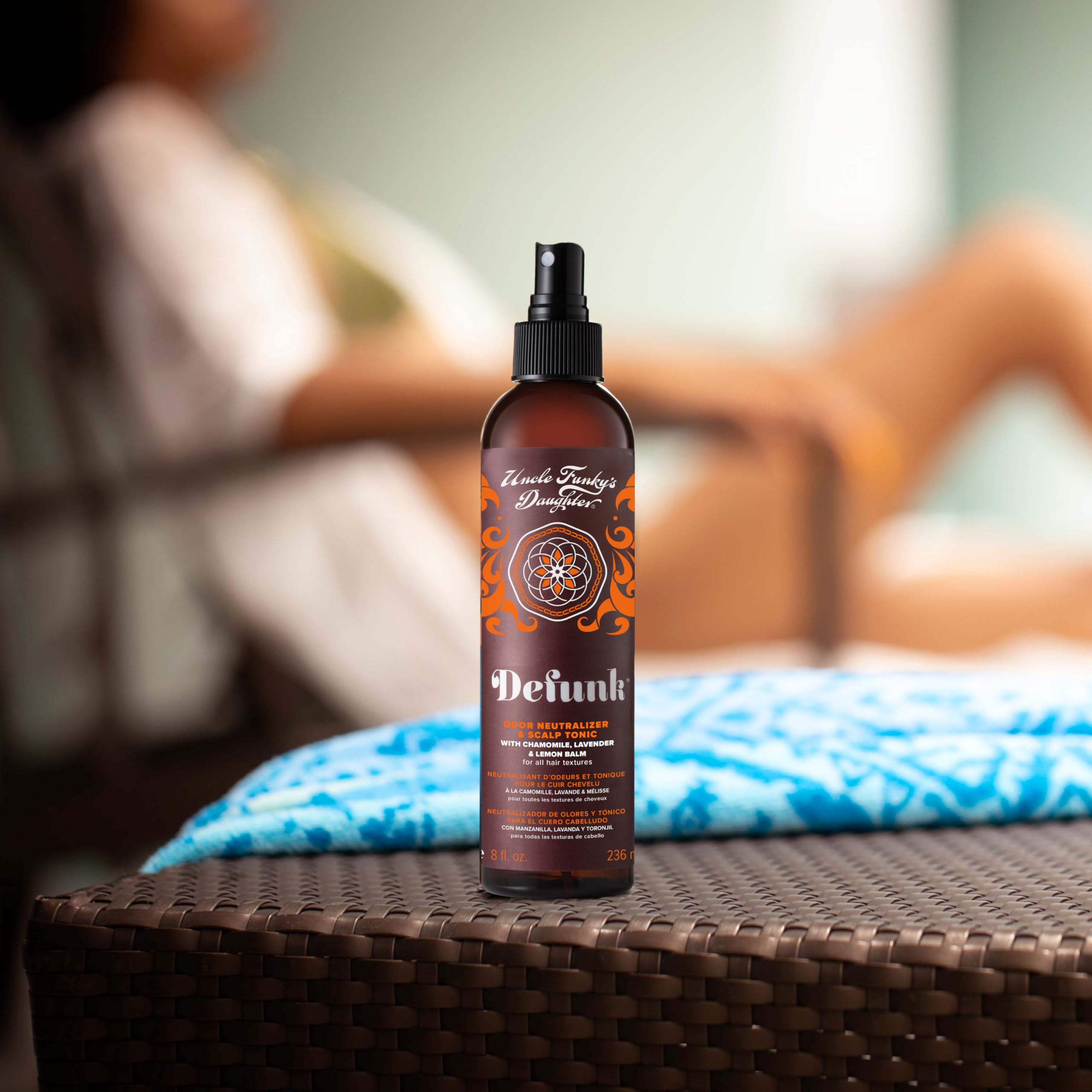 Hand applying Defunk tonic to scalp for daily refresh.