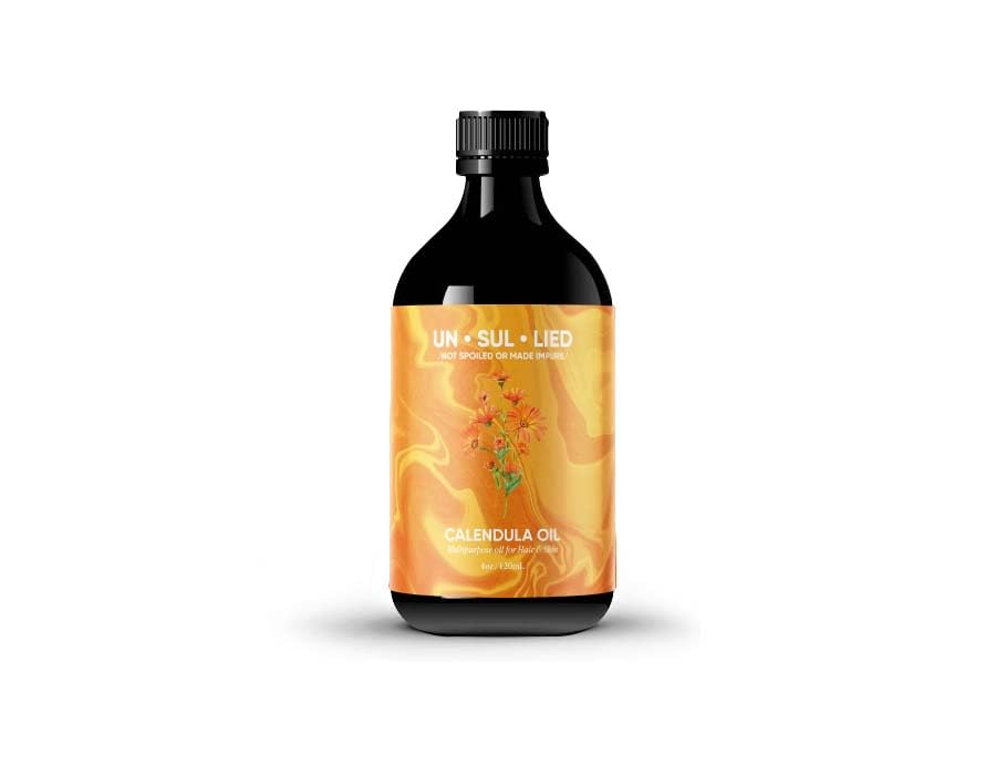 UNSULLIED Calendula Oil in amber bottle for soothing skin care.