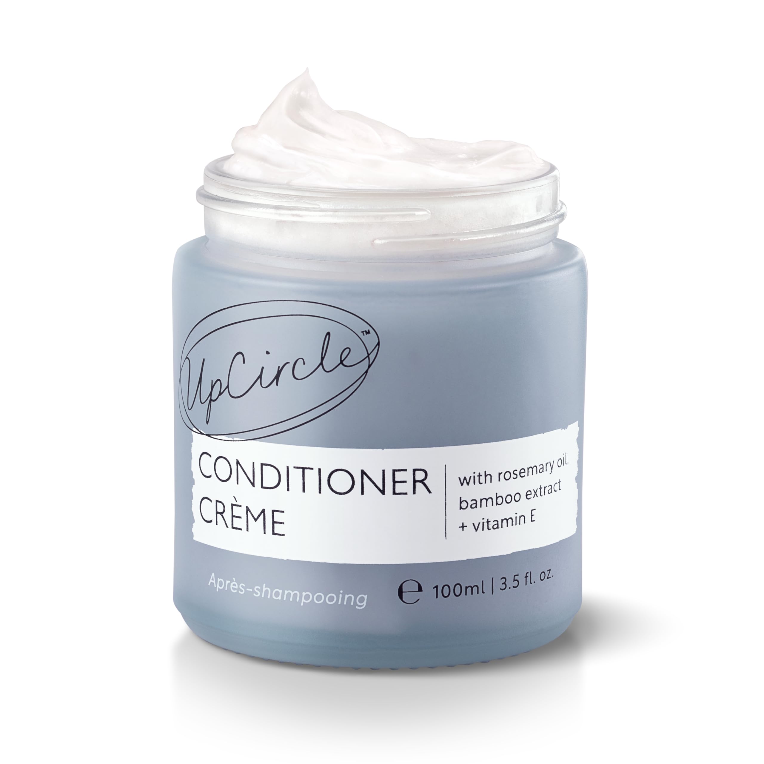 UPCIRCLE conditioner creme bottle highlights rosemary oil for gentle frizz control.