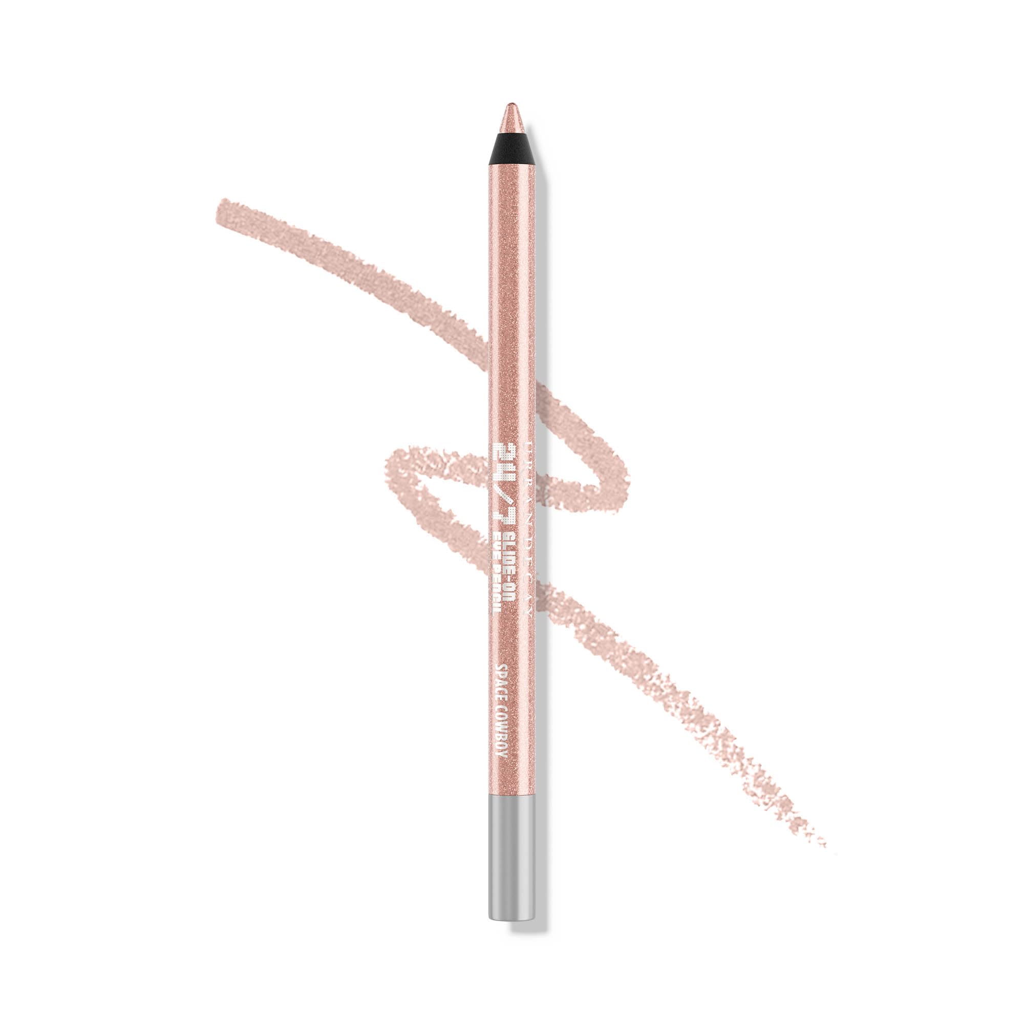 Urban Decay Space Cowboy eyeliner closeup with peach shimmer for brightening lids.