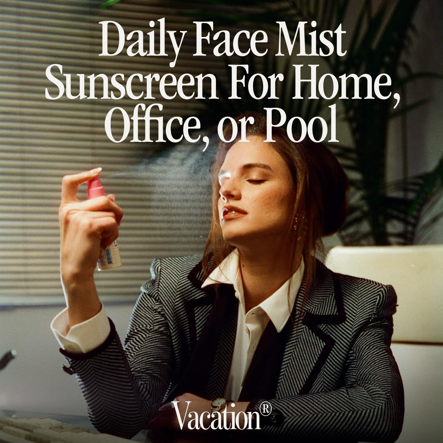 Applying Vacation Super Spritz SPF 50 face mist for quick sun protection outdoors