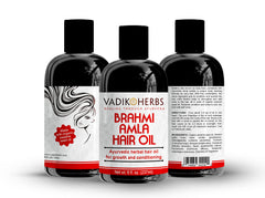 Dropper applying Vadik Herbs Brahmi Amla Hair Oil to scalp for healthier roots