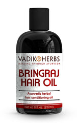 Vadik Herbs Bringraj Oil bottle pour demonstrates nourishing Ayurvedic care for hair and scalp.