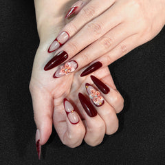 Vanpaga long burgundy stiletto nails with a glossy finish
