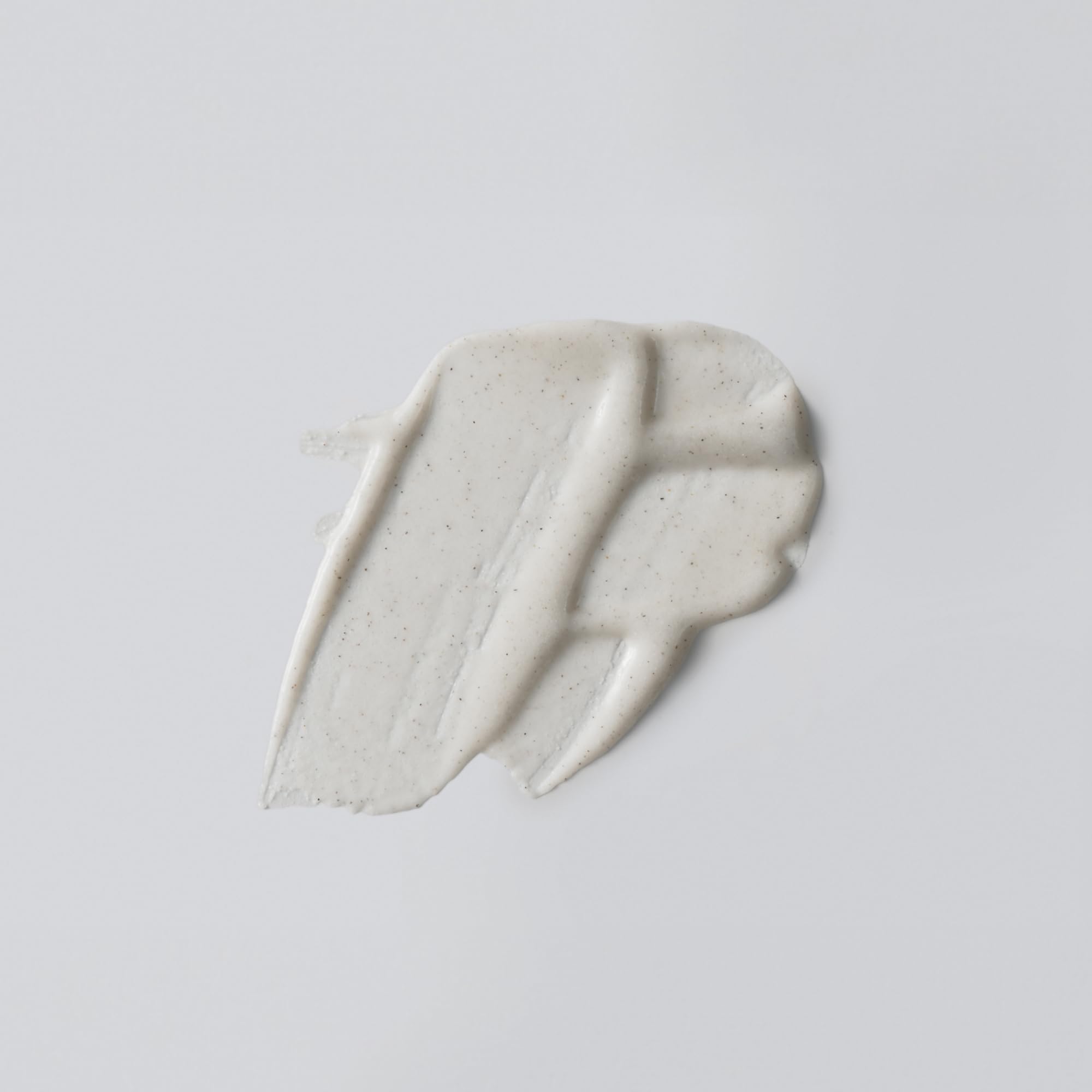 Versed Buff It Out texture closeup highlights microfine pumice for smoother skin.