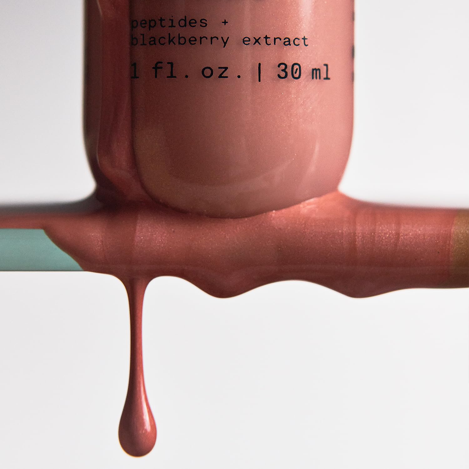 Versed Mood Lighting Glow Drops bronzed pump shows serum-like texture for hydrating glow.