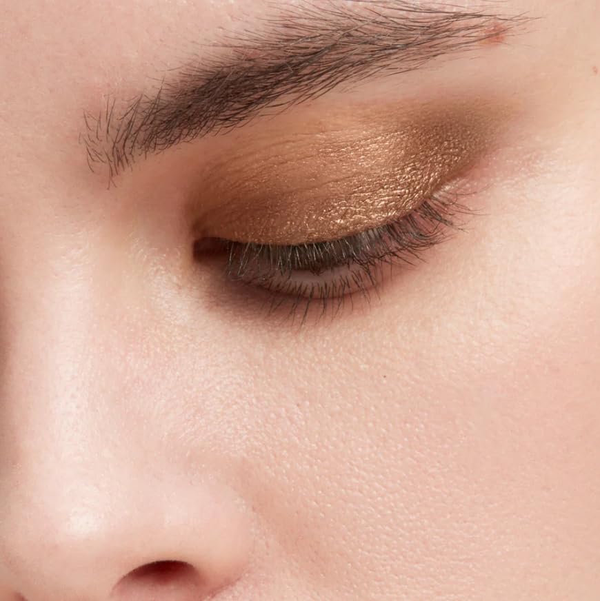 Victoria Beckham EyeWear Longwear Eyeshadow Stick Caramel swatch on arm for day-to-night versatility.