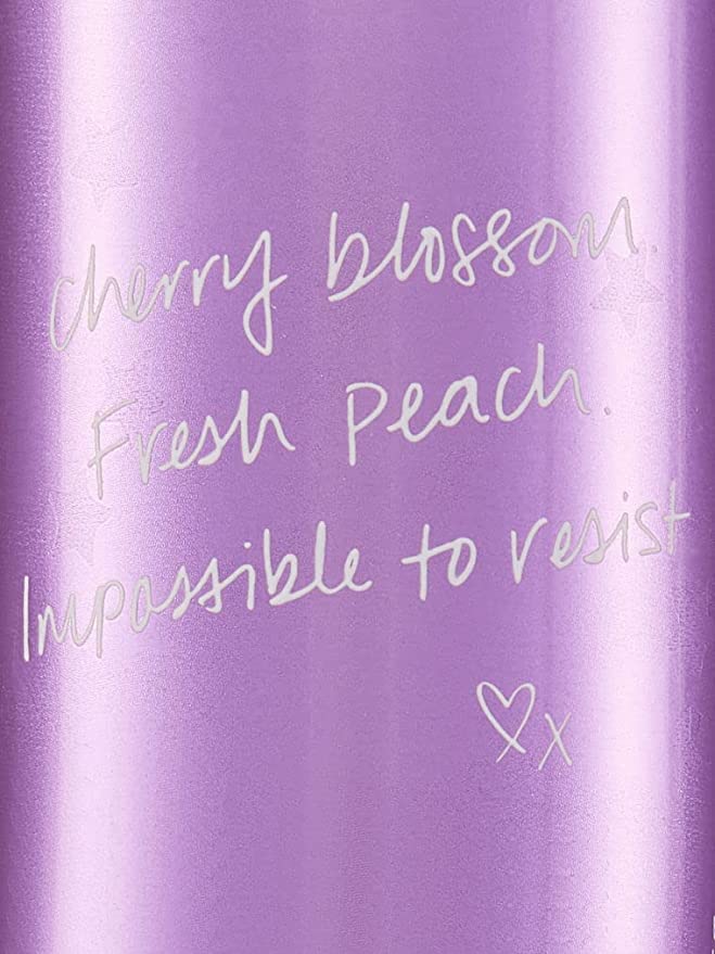 Victoria's Secret Love Spell mist bottle in hand for daily wear.