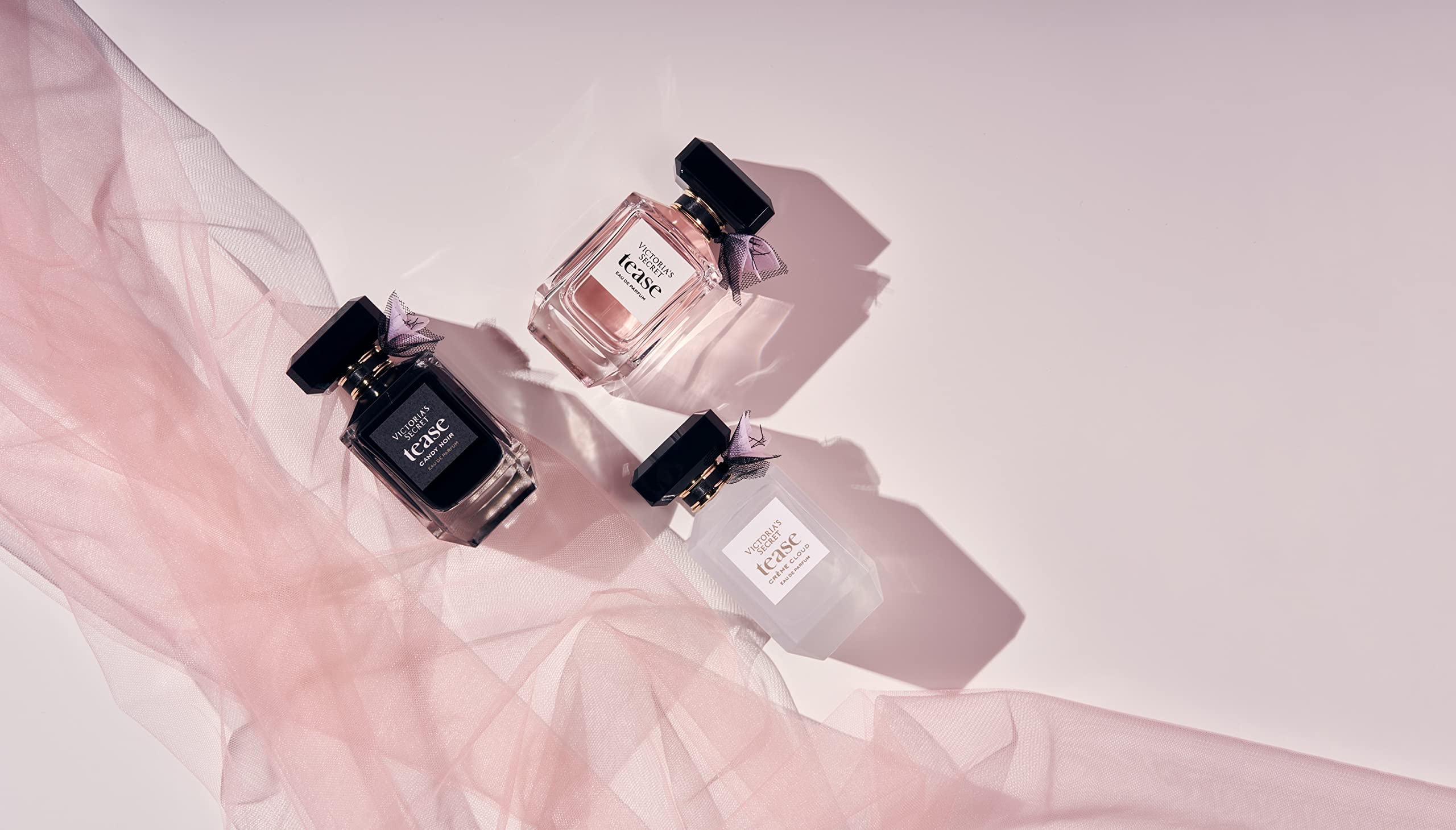 Fragrance lotion beside Tease Creme Cloud bottle for layering.