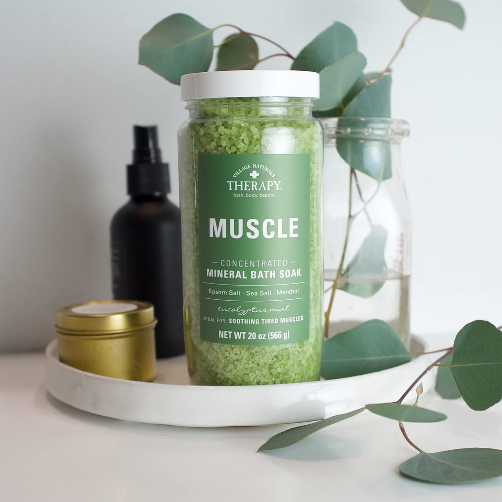 Pack of four Village Naturals Therapy Muscle Bath Soak bottles displayed