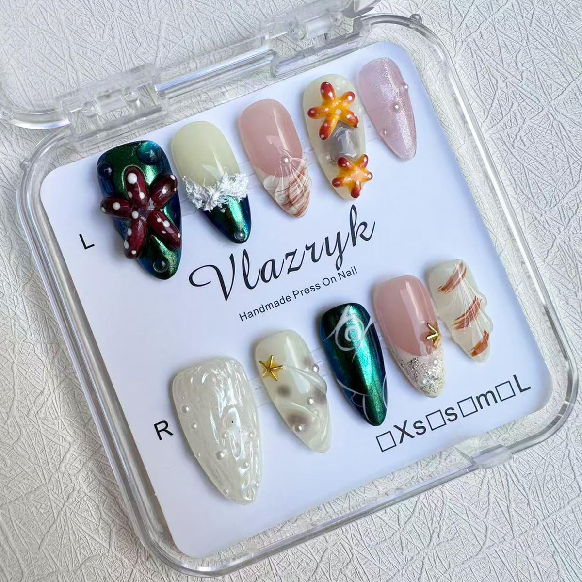 Vlazryk mermaid chrome almond nails with pearl shell accents for sea-inspired shimmer