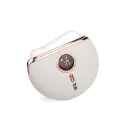 VRAIKO Aurora LED Gua Sha device on white jade with gold accents for luxurious skincare sessions.