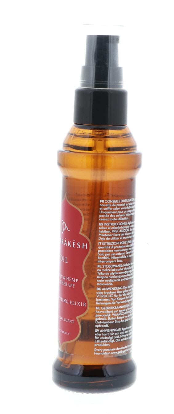 Applying Ula-style Marrakesh Oil to damp hair for smooth styling.