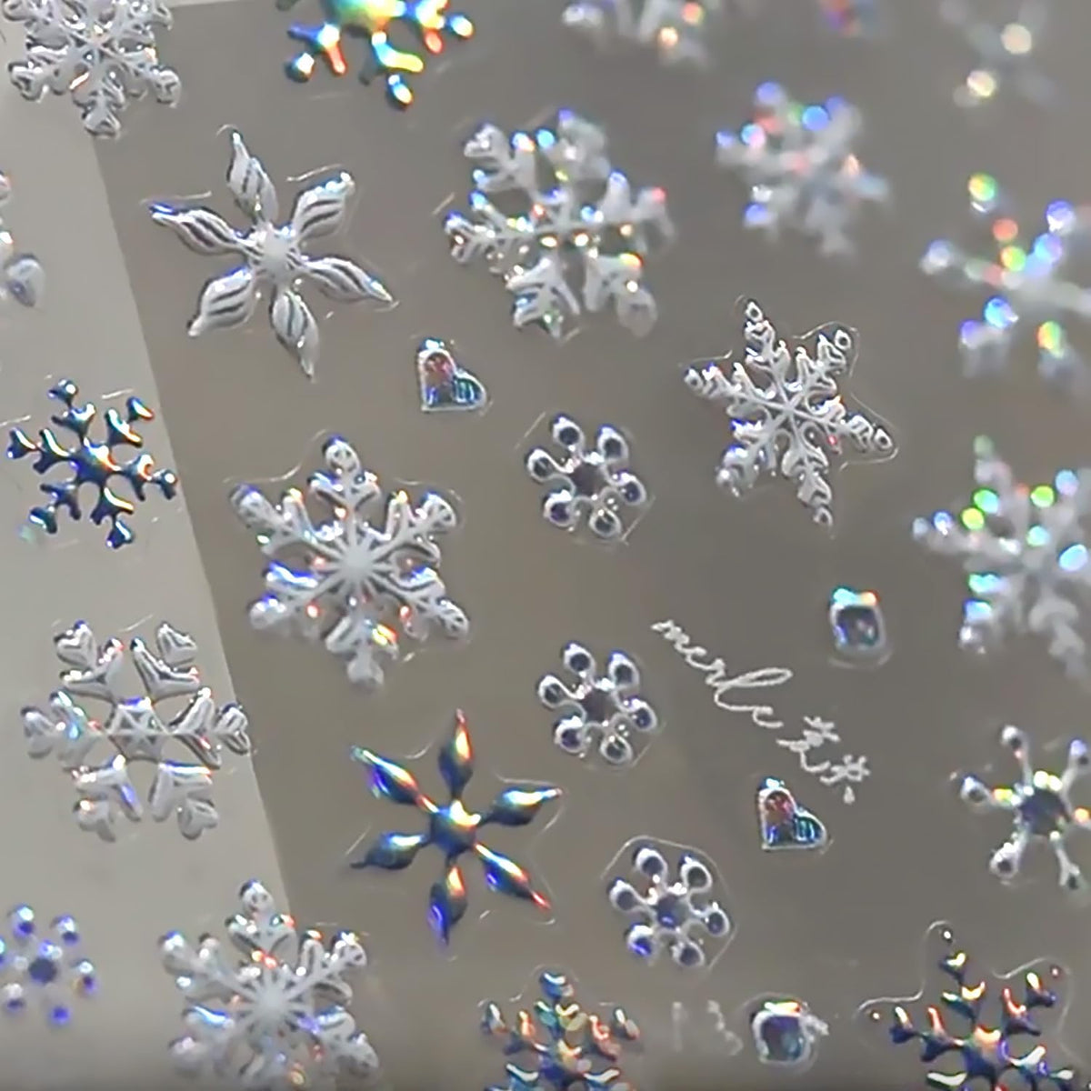 WBRRFJJ 5D embossed Christmas snowflake stickers close-up for festive nails.