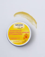 Weleda Baby Calendula Magic Balm on cheek to soothe dry skin