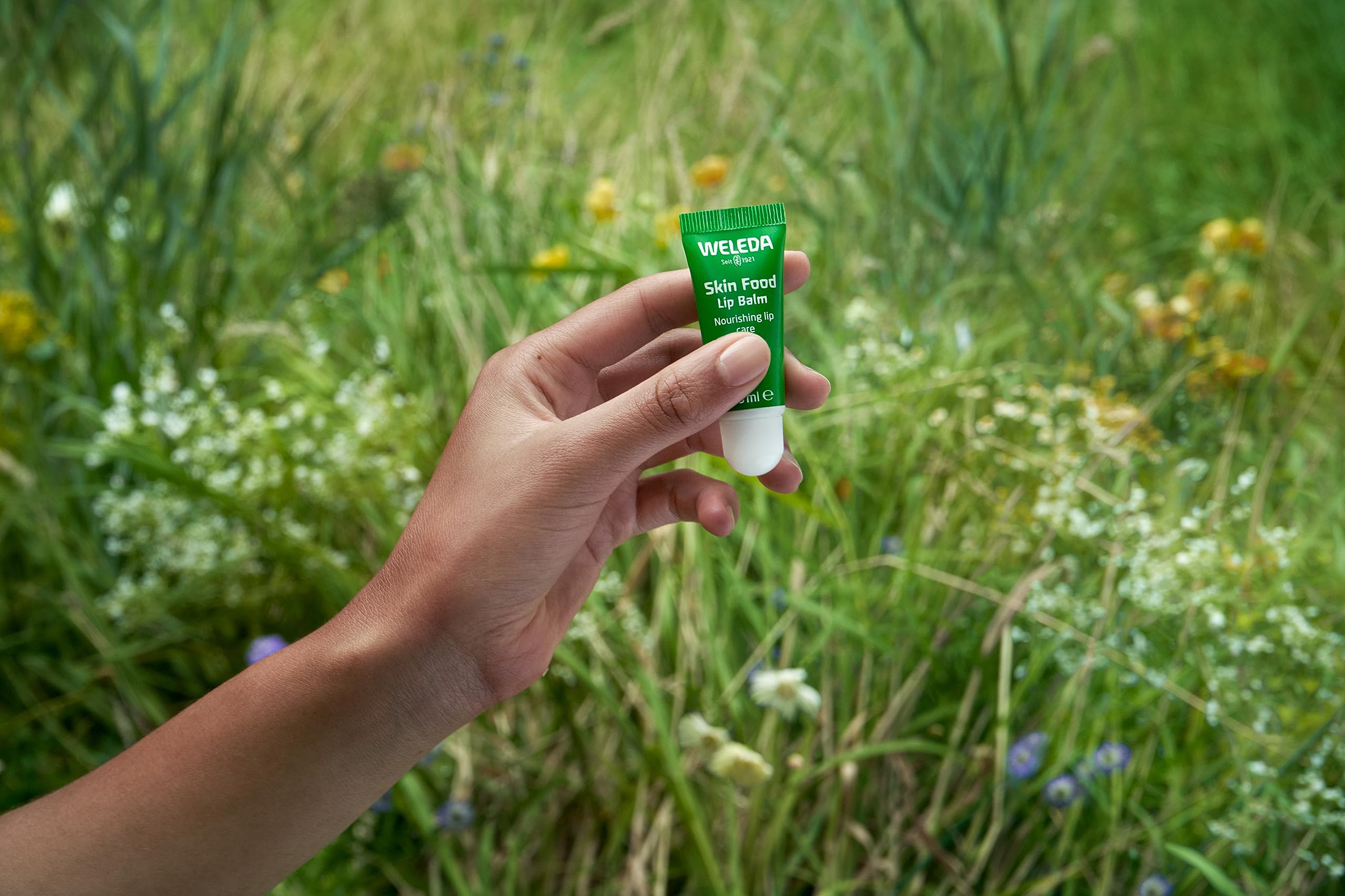 Applying Weleda Lip Butter on lips for easy nourishment