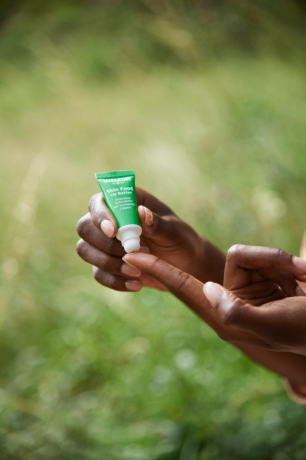Packaging of Weleda Lip Butter highlighting compact design