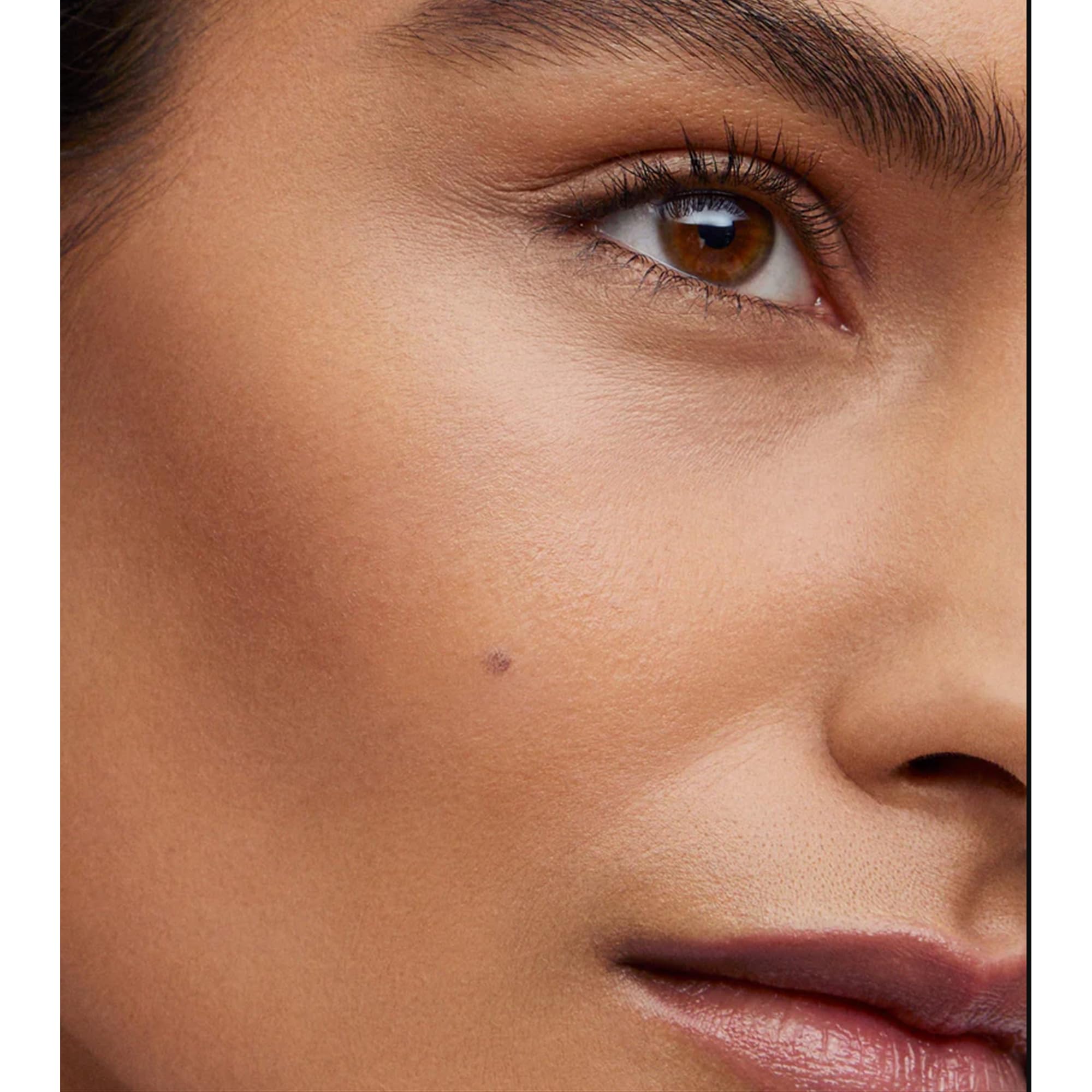 Biscuit stick in hand demonstrates smooth, non-drag application.