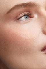 Westman Atelier Lit Up Glow Highlighter Stick Nectar shows a glassy sheen for radiant skin.