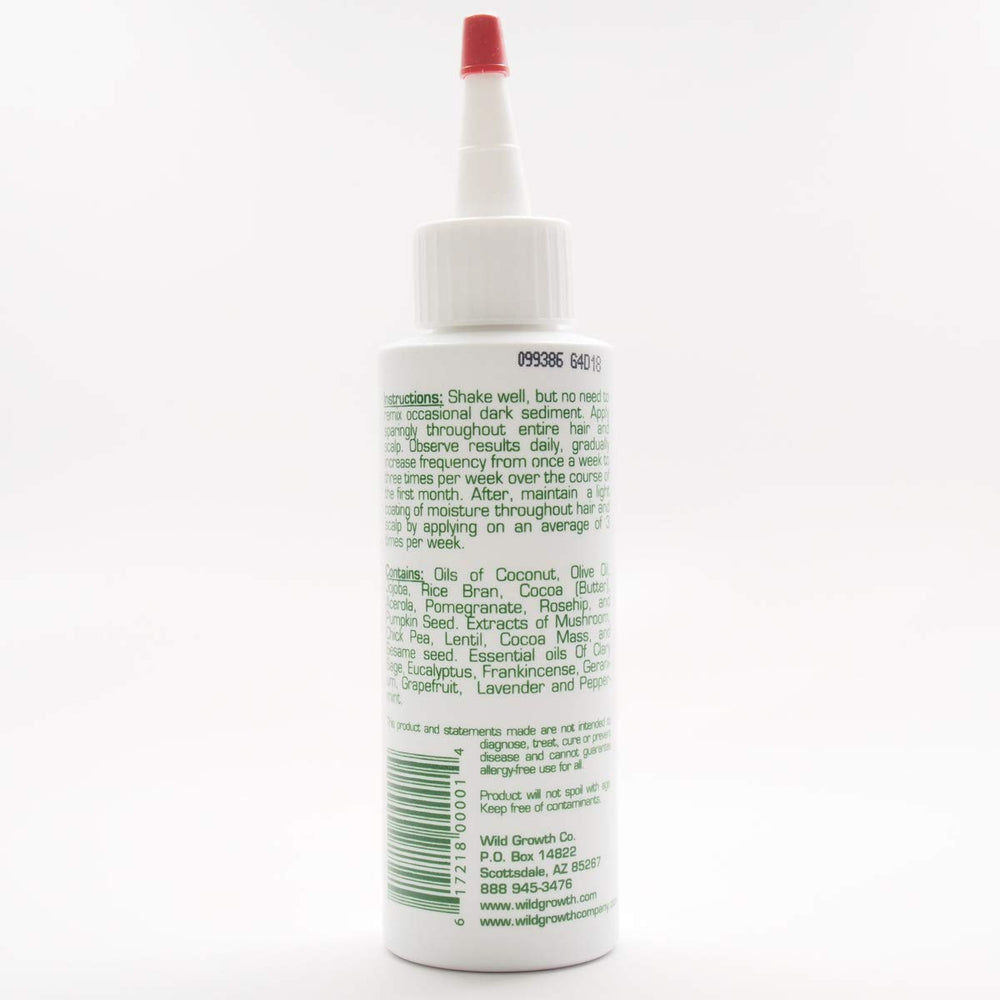 Wild Growth Hair Oil applied to hair to aid detangling and softness.